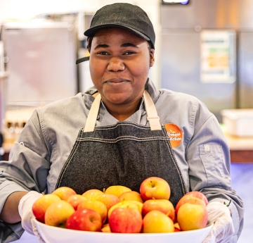 Woman holding a bowl of apples