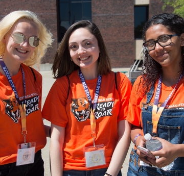 3 students wearing lanyards